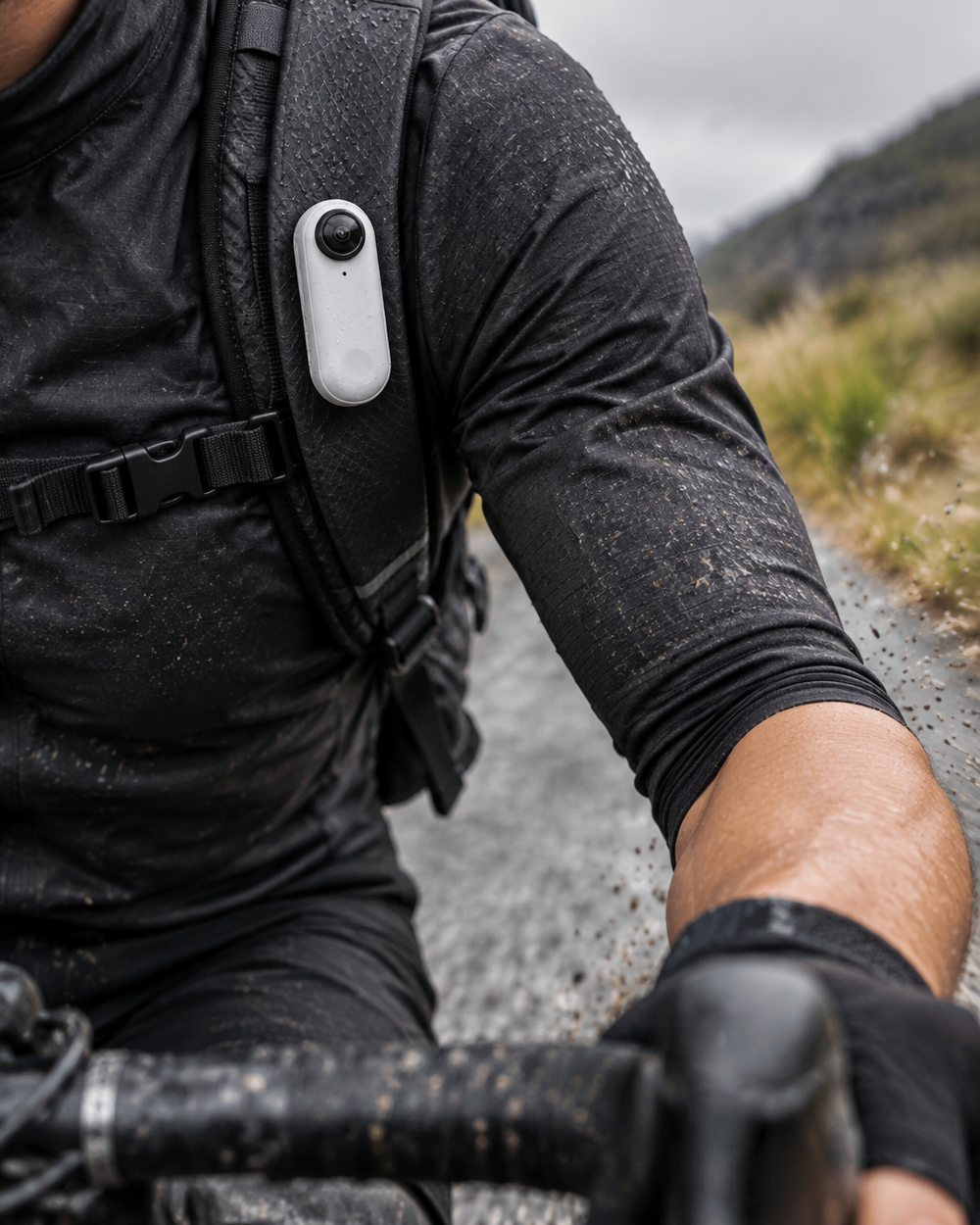 A close action photograph of the exact compact white Clipz camera magnetically secured to the should